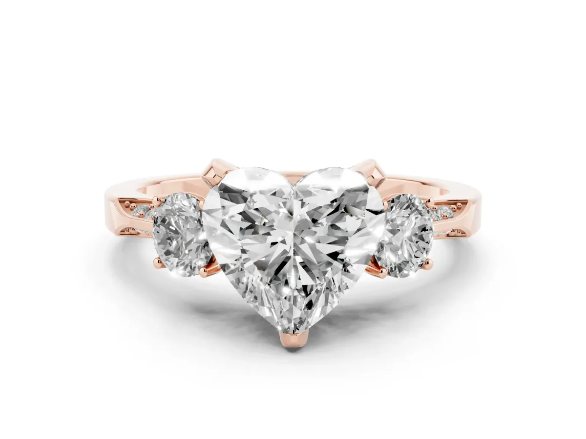 Heart Cut Diamond Three-Stone Ring Set in Rose gold with Pavé Band and Smaller Side Stones