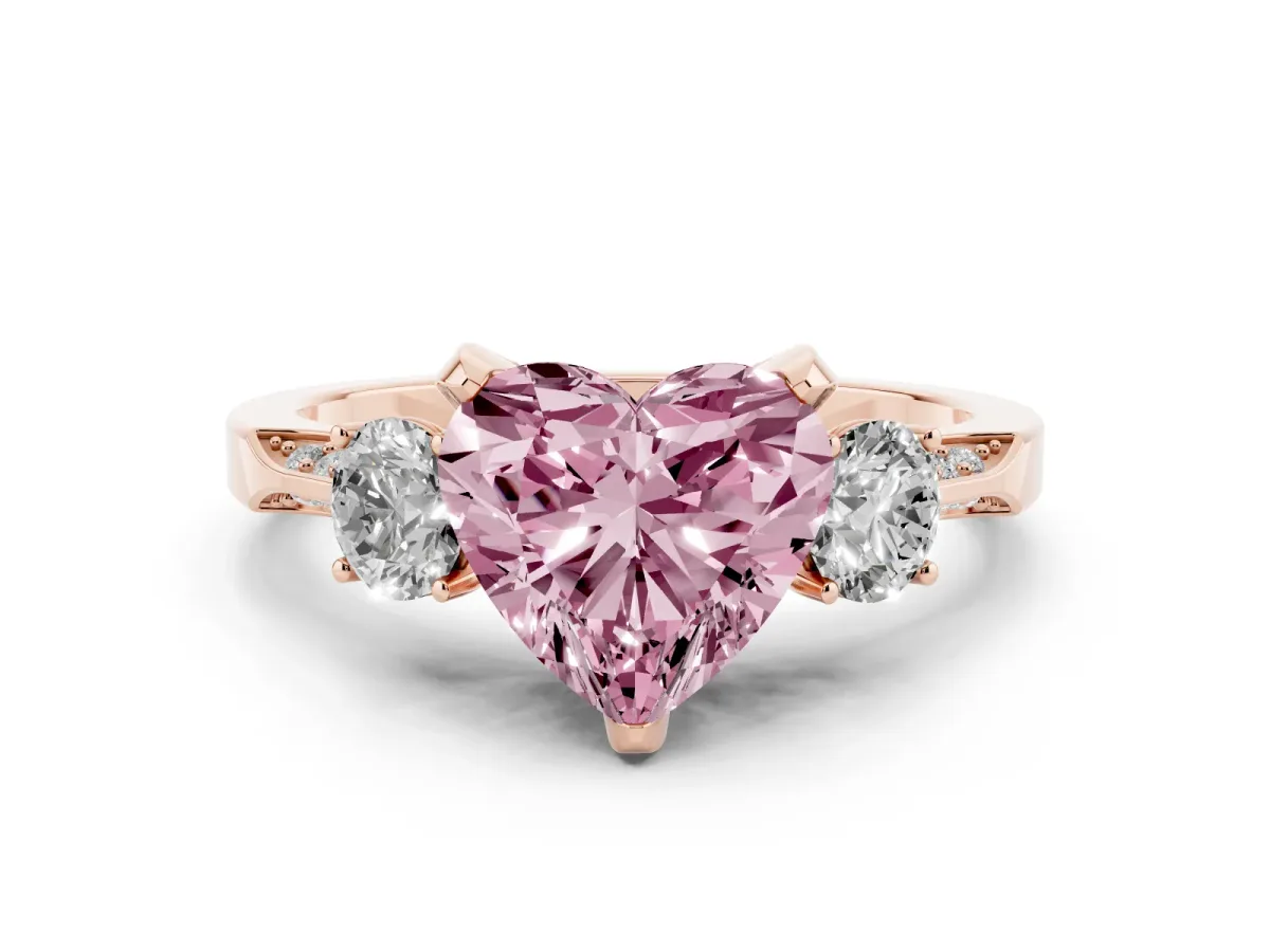 Fancy Pink Heart Cut Diamond Three-Stone Ring Set in Rose gold with Pavé Band and Smaller Side Stones