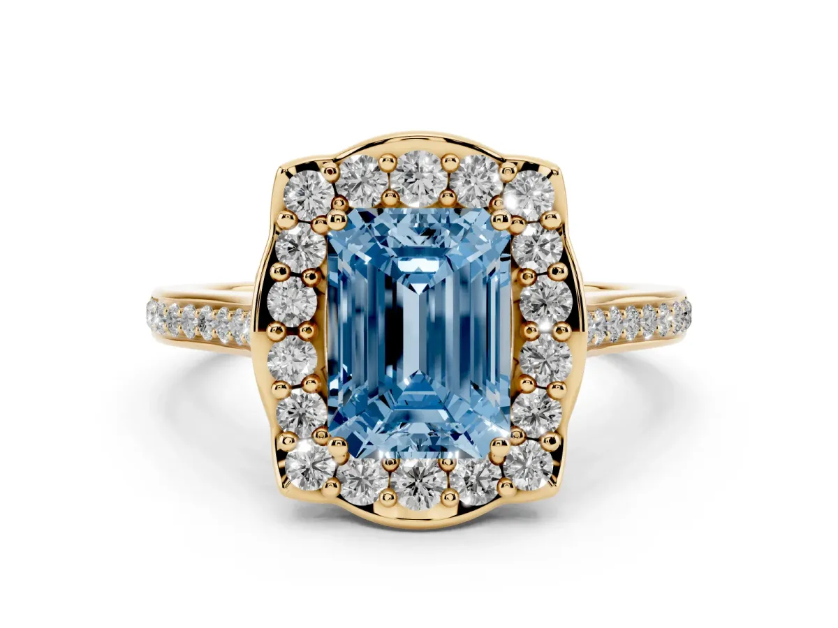 Fancy Blue Emerald Cut Diamond Halo Ring Set in Yellow gold with Pavé-Lined Shoulders and Prong Setting