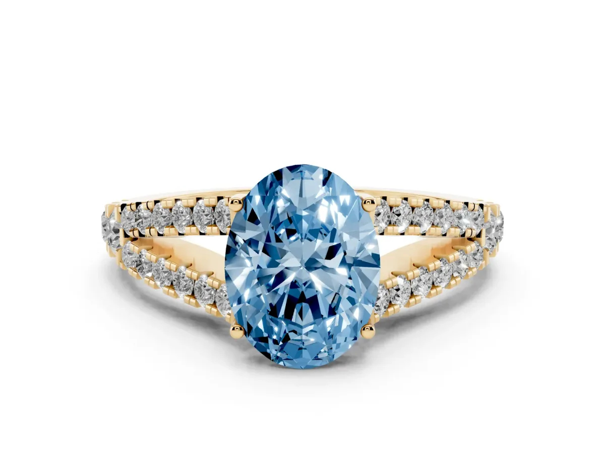 Fancy Blue Oval Cut Diamond Split Shank Pavé Engagement Ring Set in Yellow gold with Prong-Held Center Stone