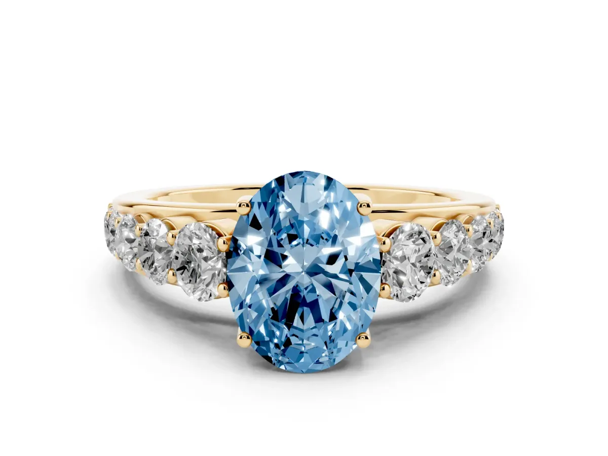 Fancy Blue Oval Cut Diamond Solitaire Ring Set in Yellow gold with Pavé-Set Band and Prong Setting