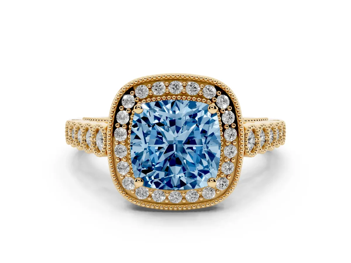Fancy Blue Cushion Cut Diamond Milgrain Halo Solitaire Ring Set in Yellow gold with Bezel Set Side Stones and Pavé Band
