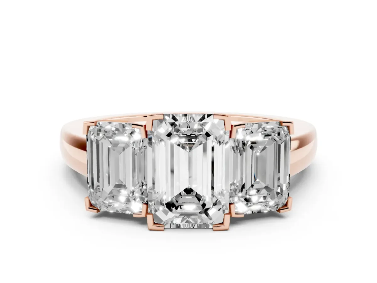Emerald Cut Diamond Three-Stone Ring Set in Rose gold with Channel-Set Band and Prong Settings