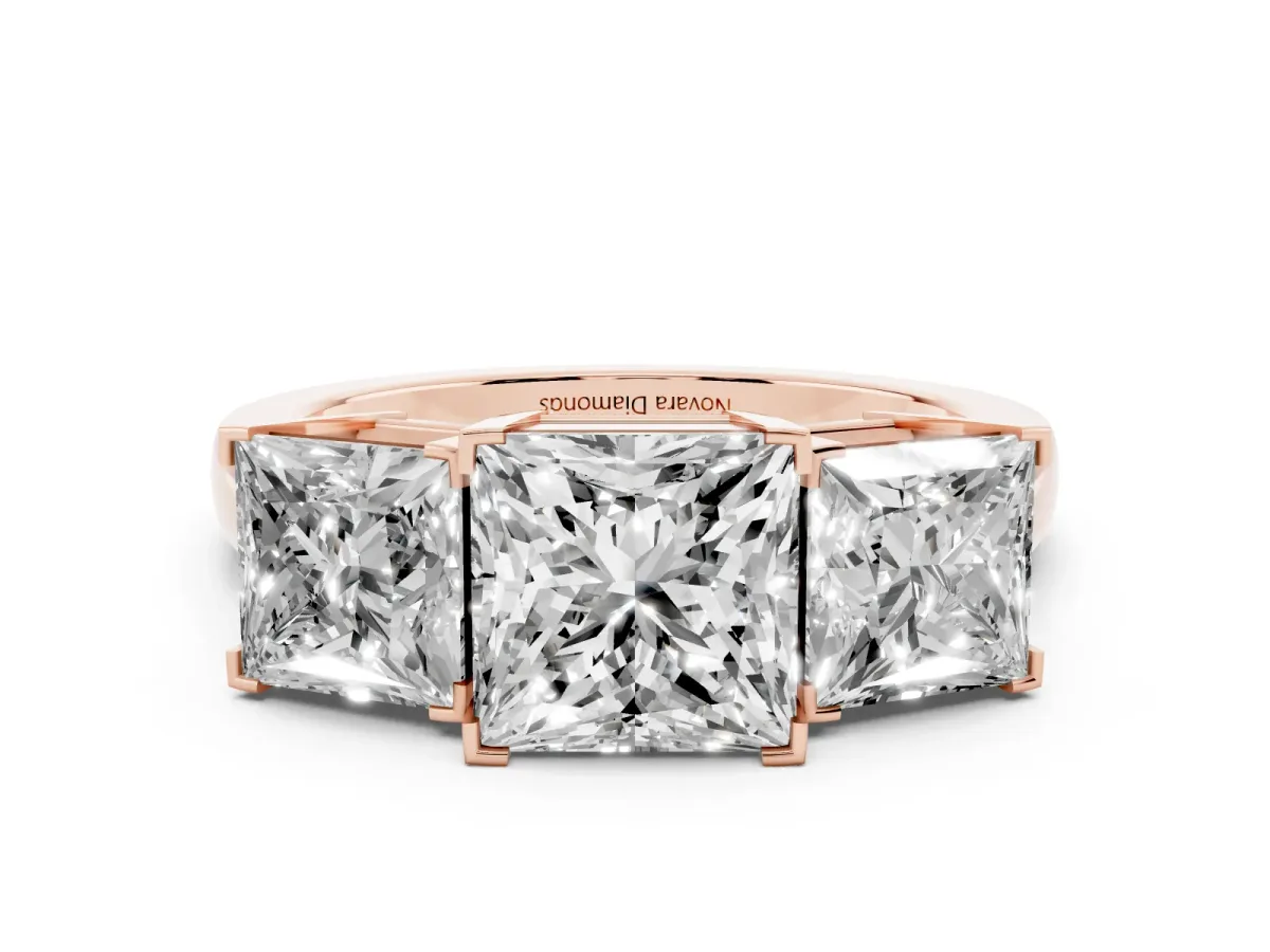 Princess Cut Diamond Three-Stone Ring Set in Rose gold with Channel-Set Band and Prong Settings