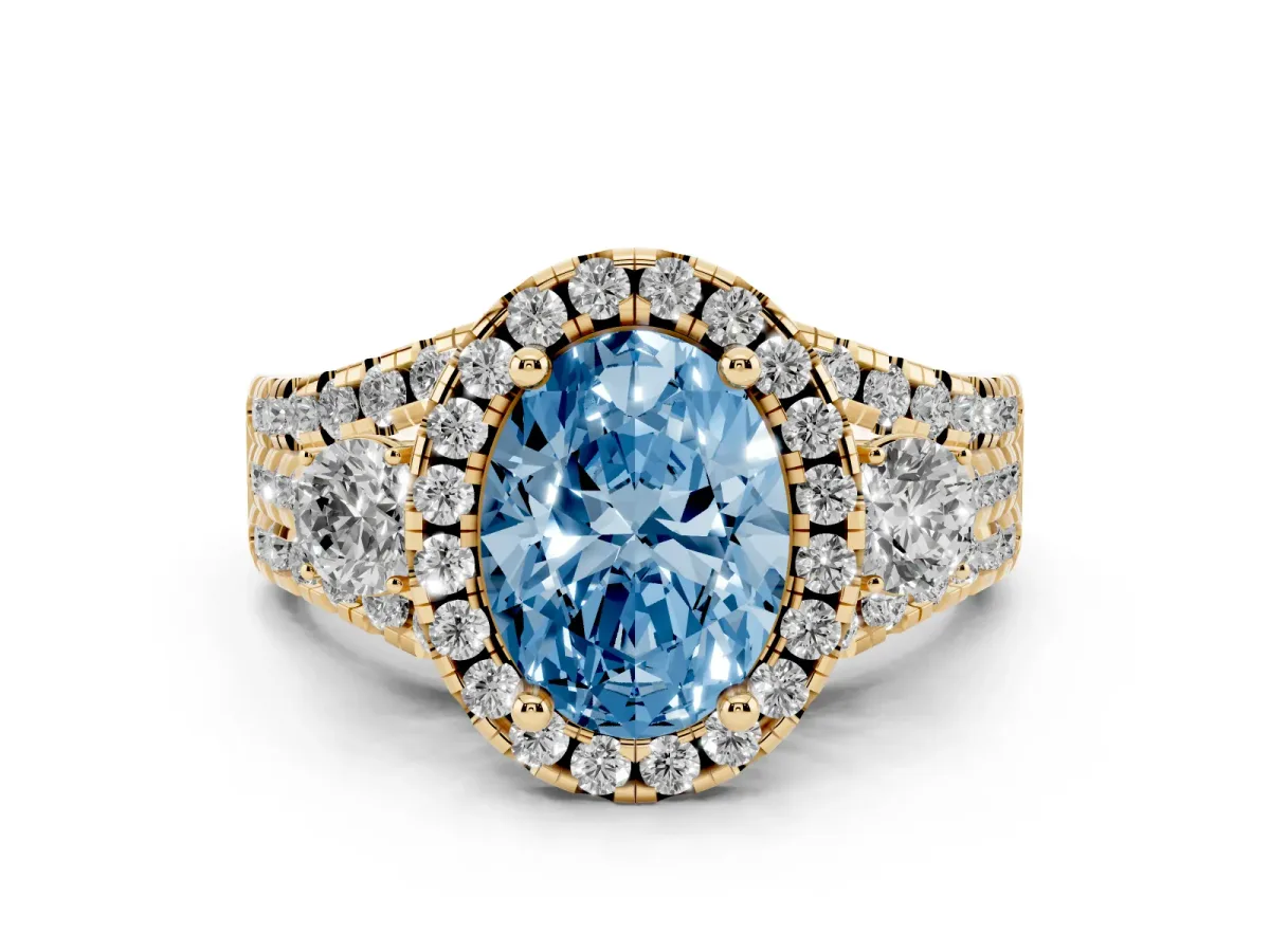 Fancy Blue Oval Cut Diamond Halo Split Shank Ring Set in Yellow gold with Round Accent Stones and Prong Setting