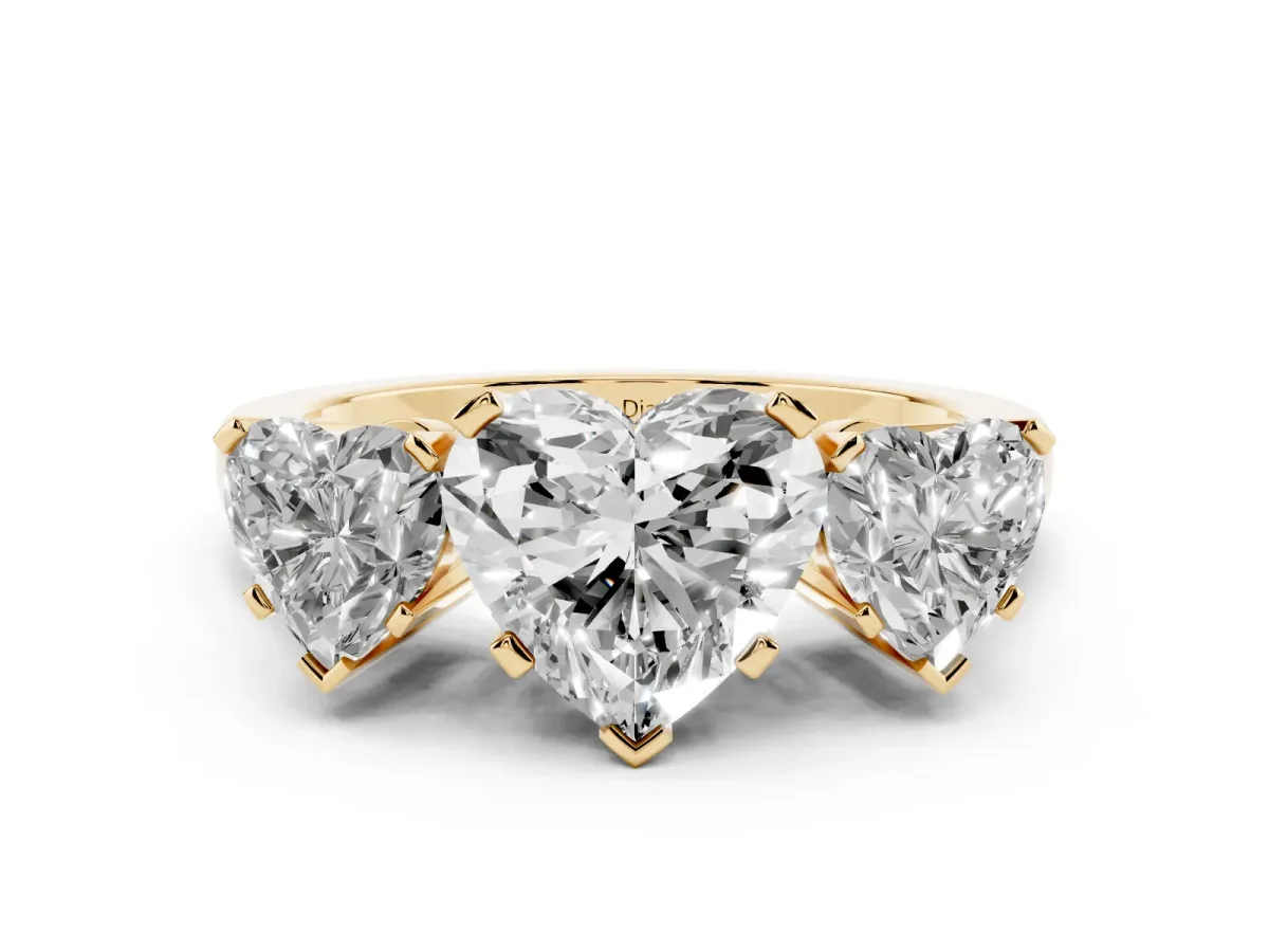 Heart Cut Diamond Three-Stone Ring Set in Yellow gold with Channel-Set Band and Prong Settings