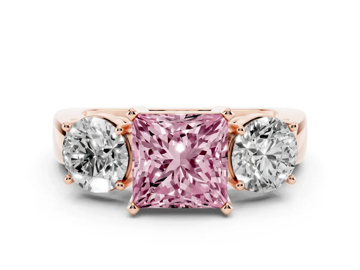 Fancy Pink Princess Cut Diamond Three-Stone Ring Set in Rose gold with Round Side Stones and Classic Band