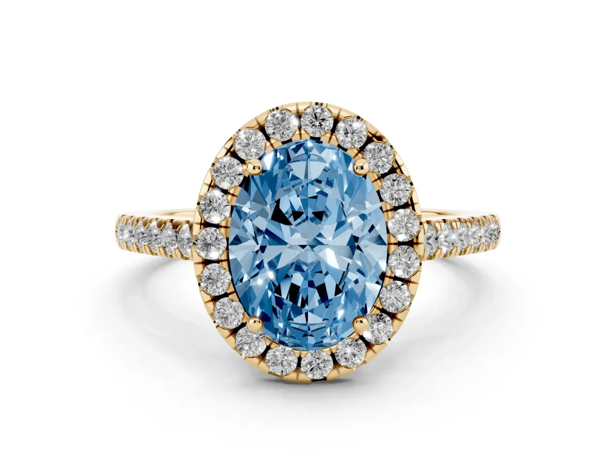 Fancy Blue Oval Cut Diamond Pavé Halo Engagement Ring Set in Yellow gold with Pavé Band and Prong Setting