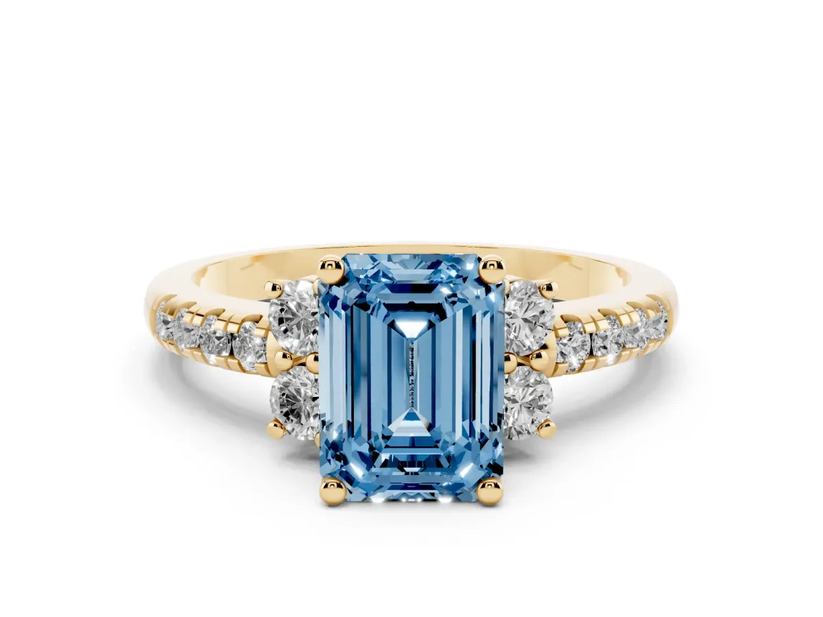 Fancy Blue Emerald Cut Diamond Three-Stone Pavé Ring Set in Yellow gold with Prong Setting