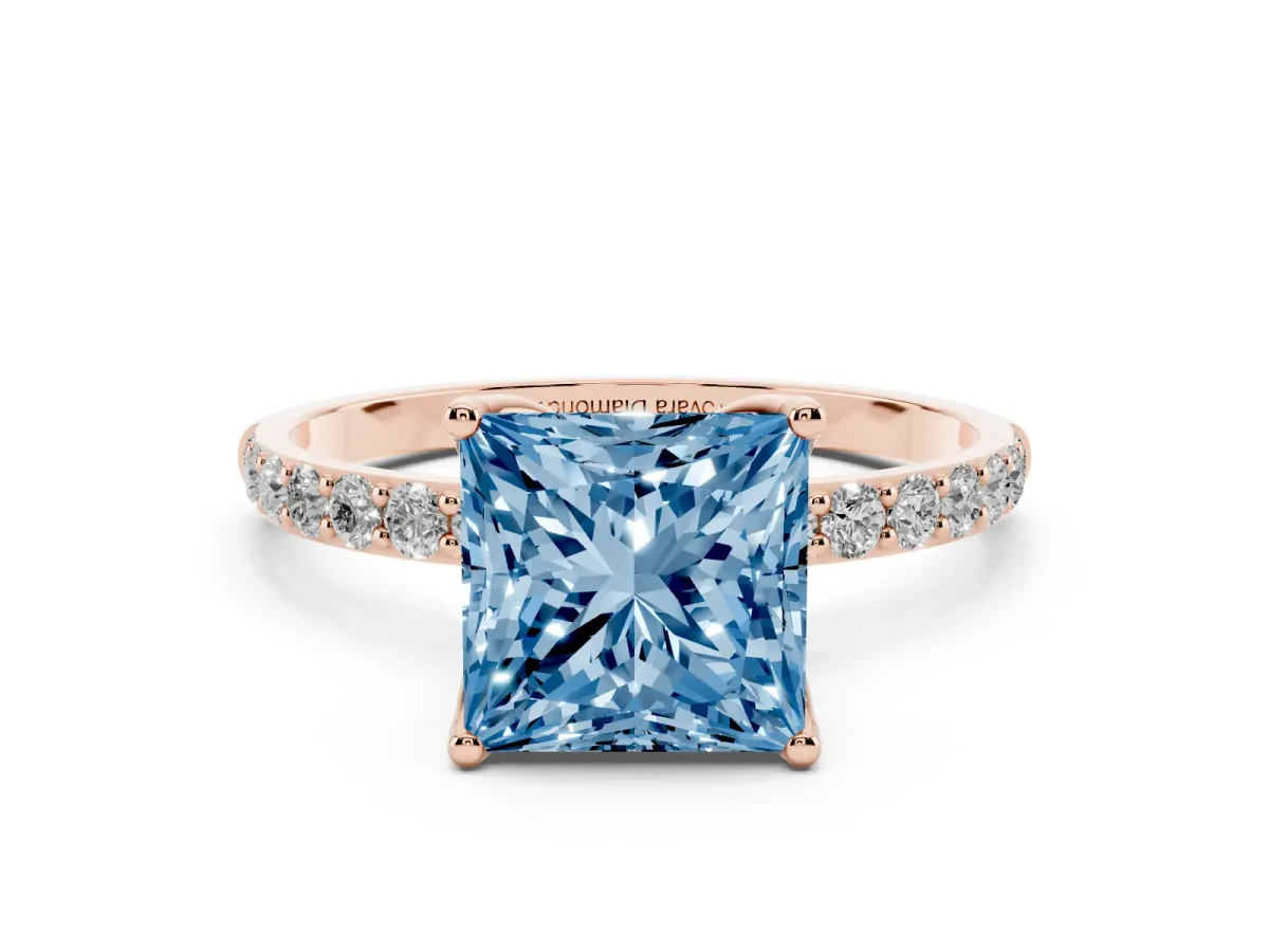 Fancy Blue Princess Cut Diamond Solitaire Engagement Ring Set in Rose gold with Round Pavé Band and Prong Setting