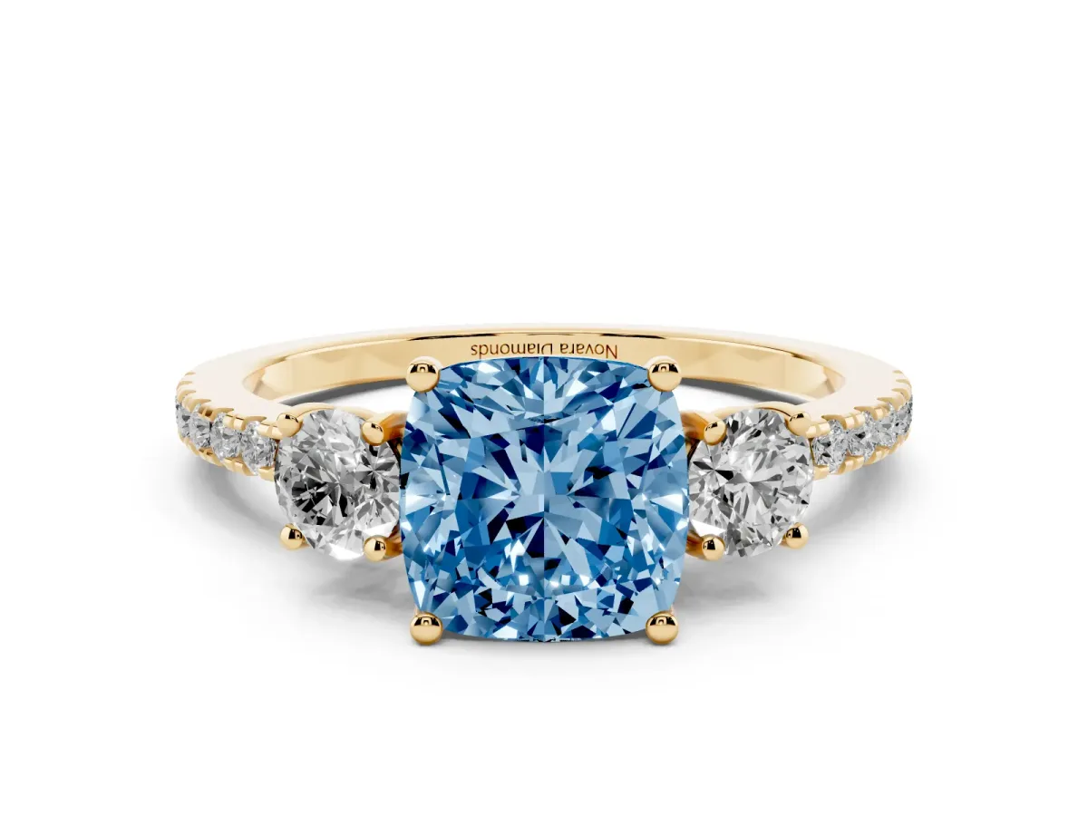 Fancy Blue Cushion Cut Diamond Three-Stone Ring Set in Yellow gold with Pavé Band and Graduated Sides