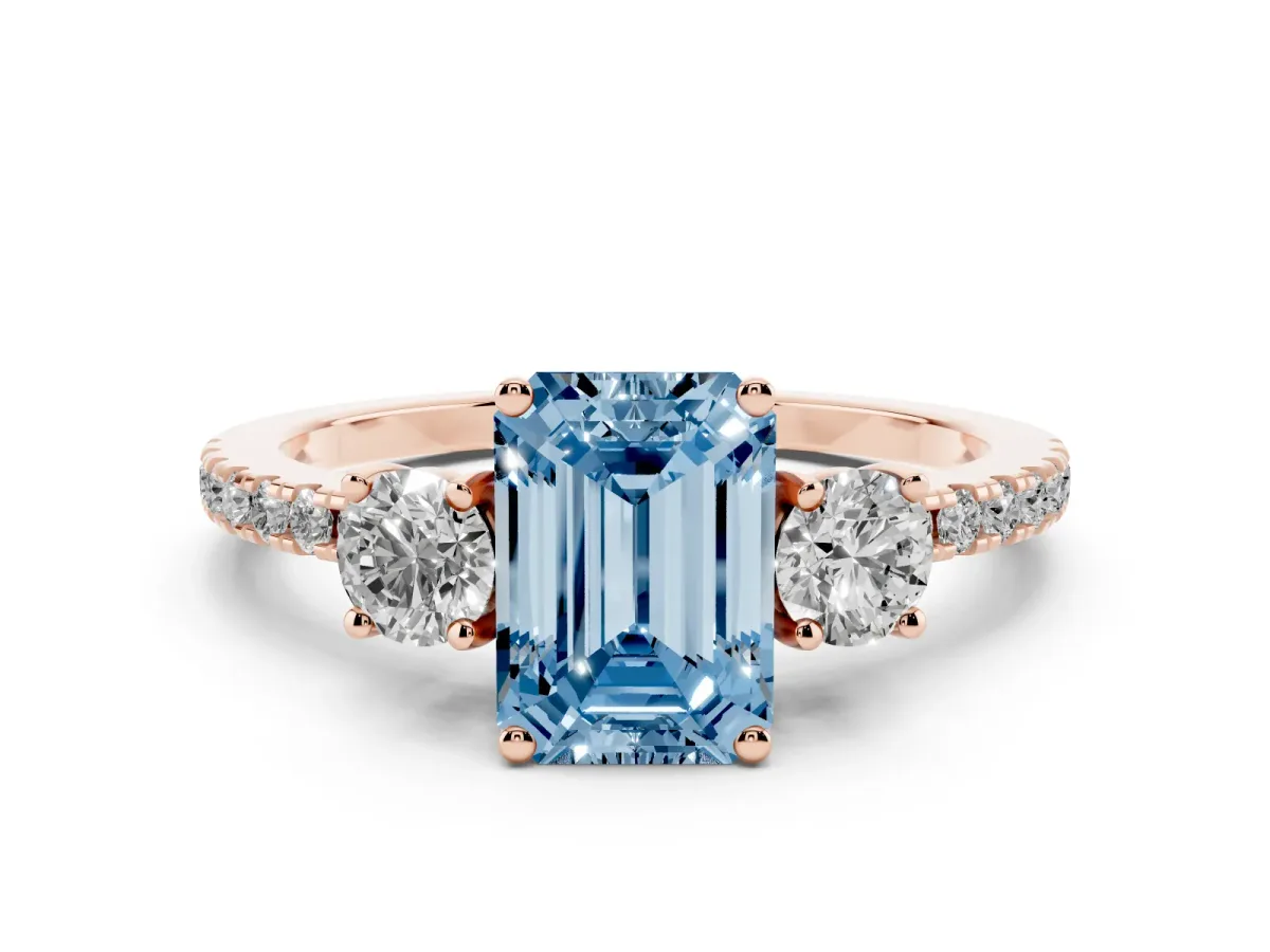 Fancy Blue Emerald Cut Diamond Three-Stone Ring Set in Rose gold with Pavé Band and Graduated Sides