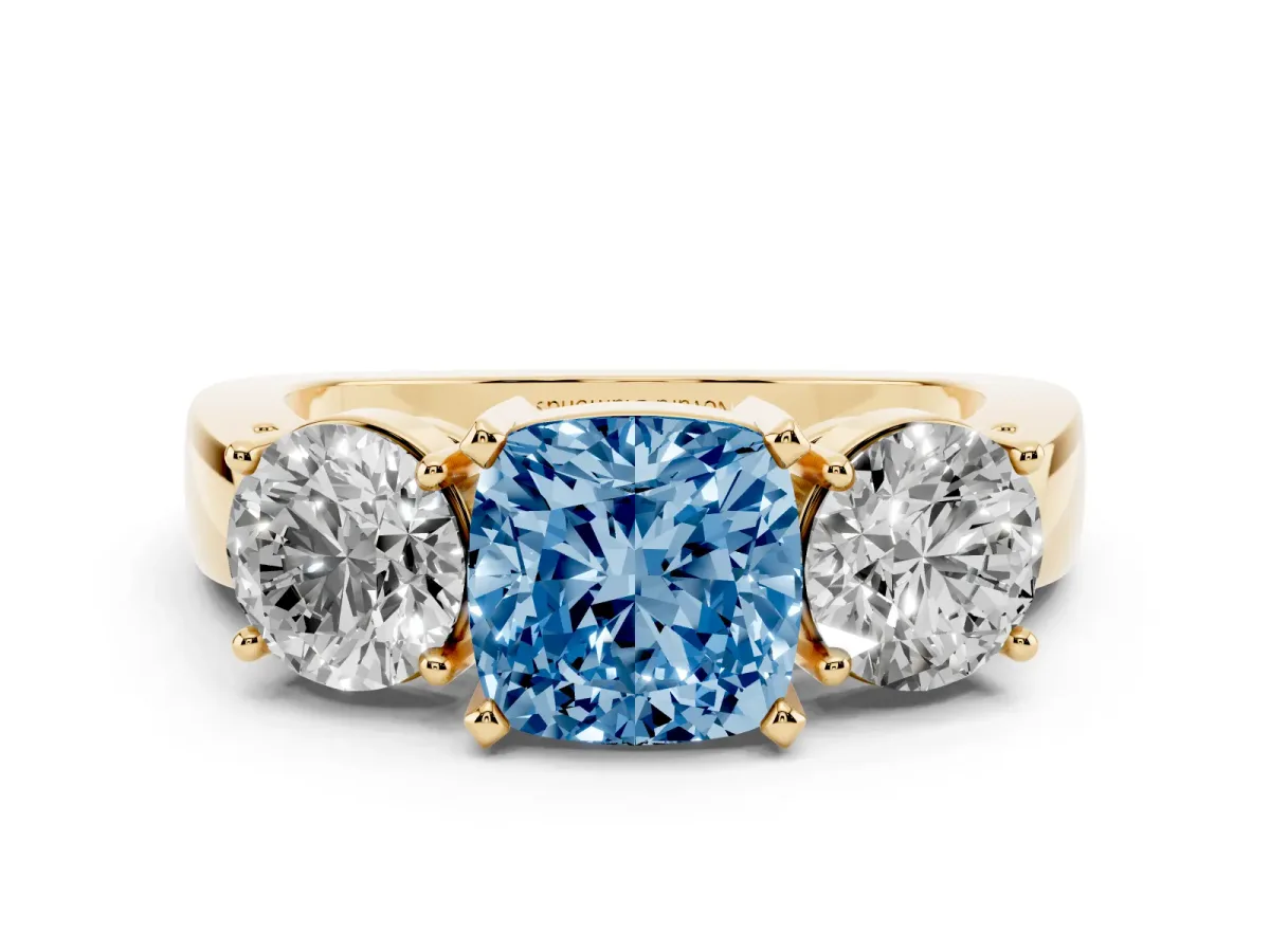 Fancy Blue Cushion Cut Diamond Three-Stone Ring Set in Yellow gold with Round Side Stones and Classic Band