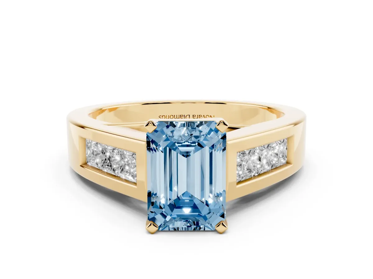 Fancy Blue Emerald Cut Diamond Solitaire Ring Set in Yellow gold with Channel-Set Accent Stones and Prong Setting
