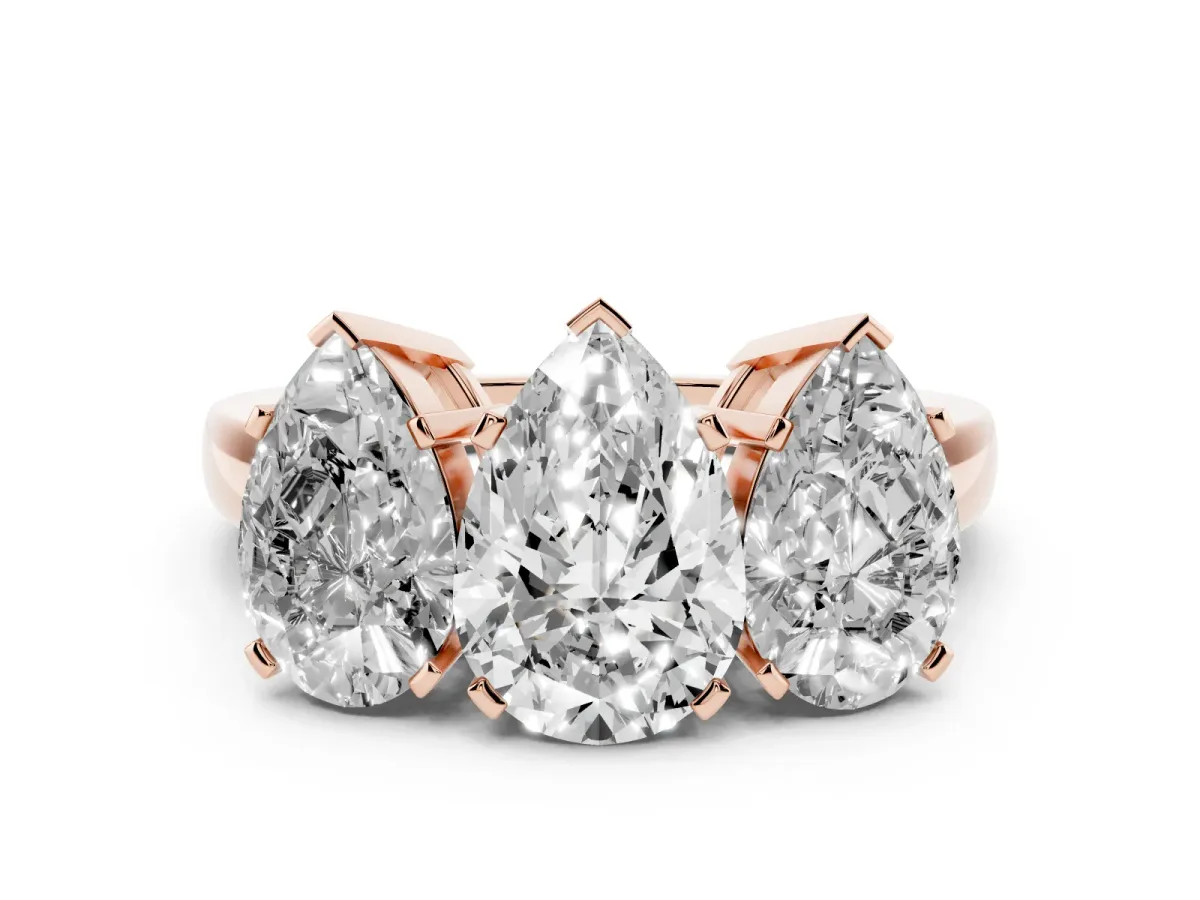 Pear Cut Diamond Three-Stone Ring Set in Rose gold with Channel-Set Band and Prong Settings