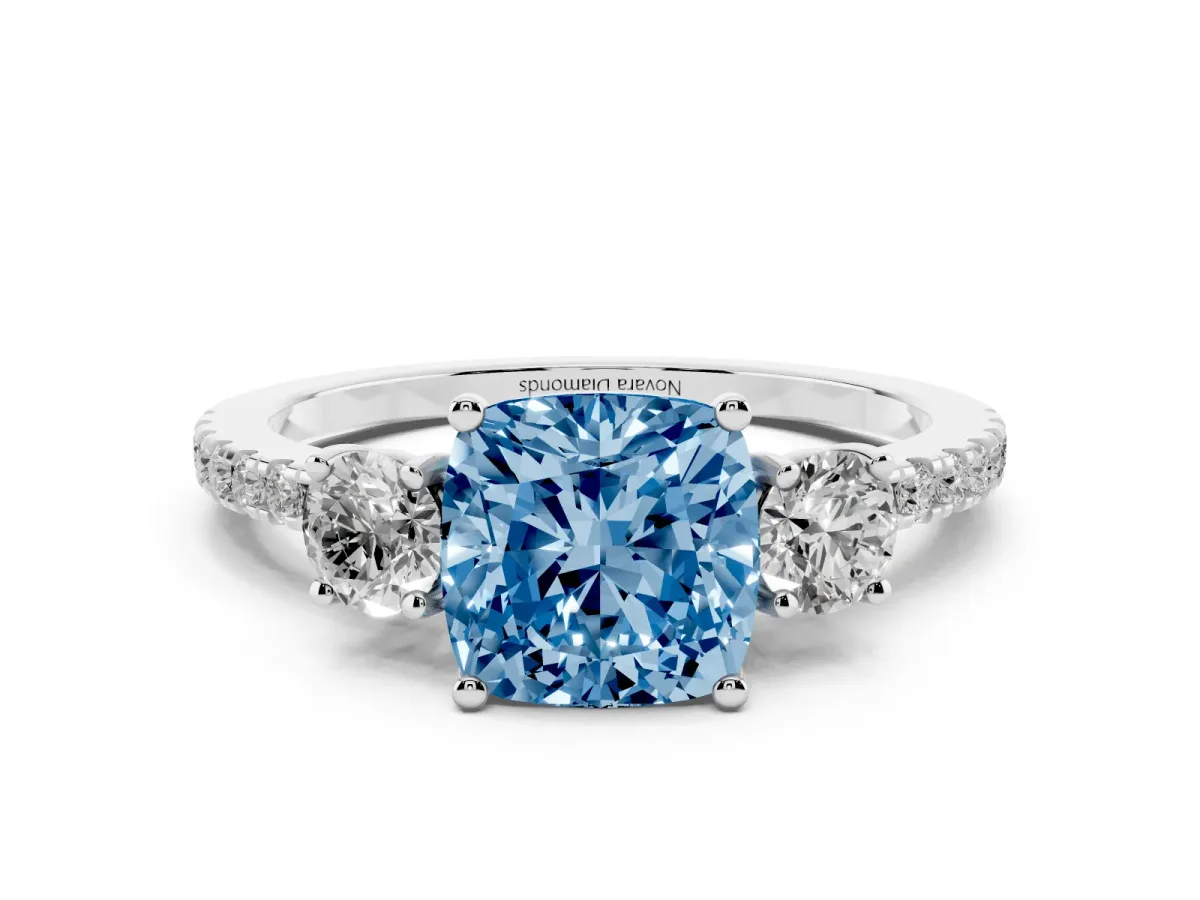 Fancy Blue Cushion Cut Diamond Three-Stone Ring Set in White gold with Pavé Band and Graduated Sides