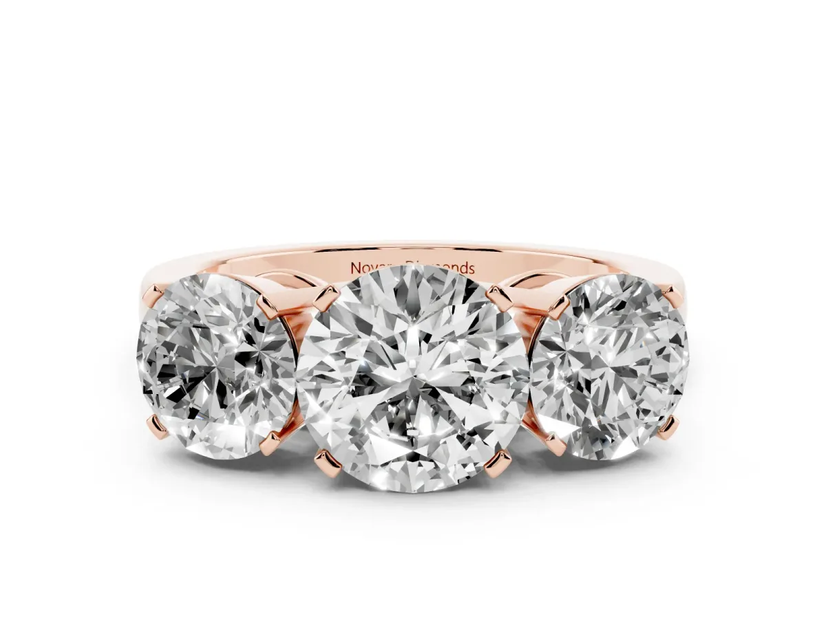 Round Cut Diamond Three-Stone Ring Set in Rose gold with Channel-Set Band and Prong Settings
