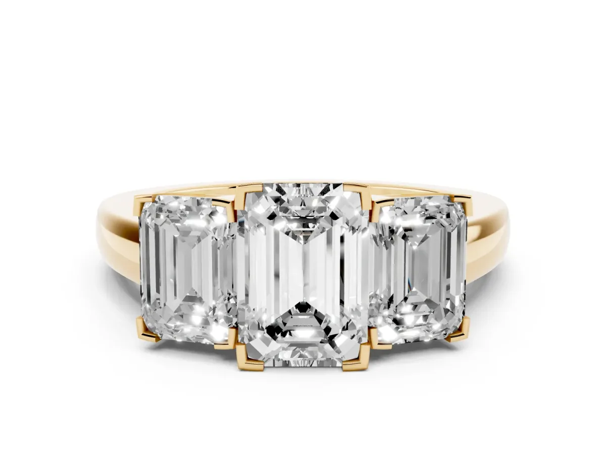 Emerald Cut Diamond Three-Stone Ring Set in Yellow gold with Channel-Set Band and Prong Settings