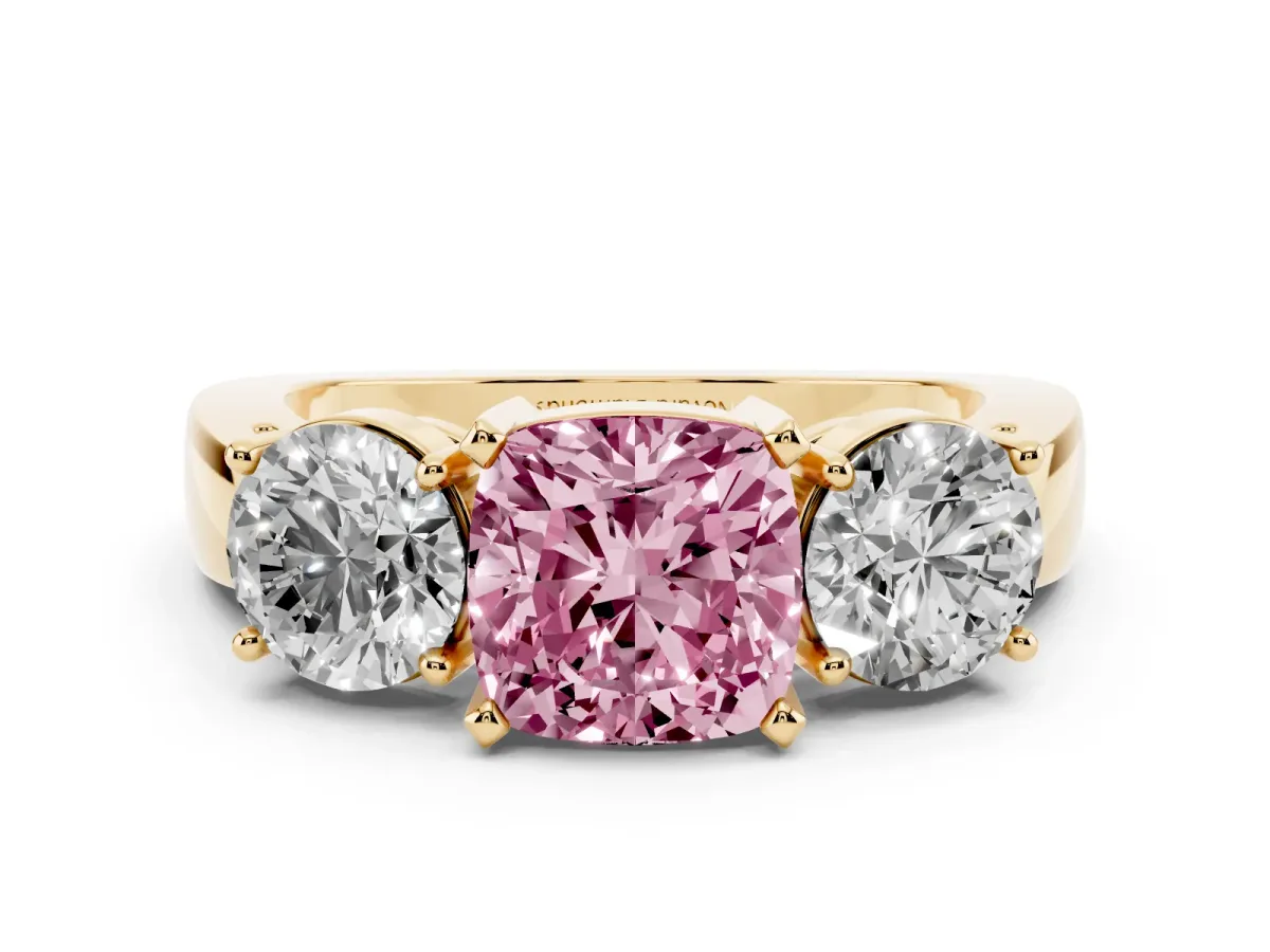 Fancy Pink Cushion Cut Diamond Three-Stone Ring Set in Yellow gold with Round Side Stones and Classic Band