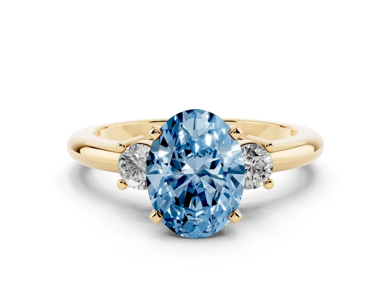 Fancy Blue Three-Stone Oval Cut Diamond Ring Set in Yellow gold with Prong Setting and Plain Band