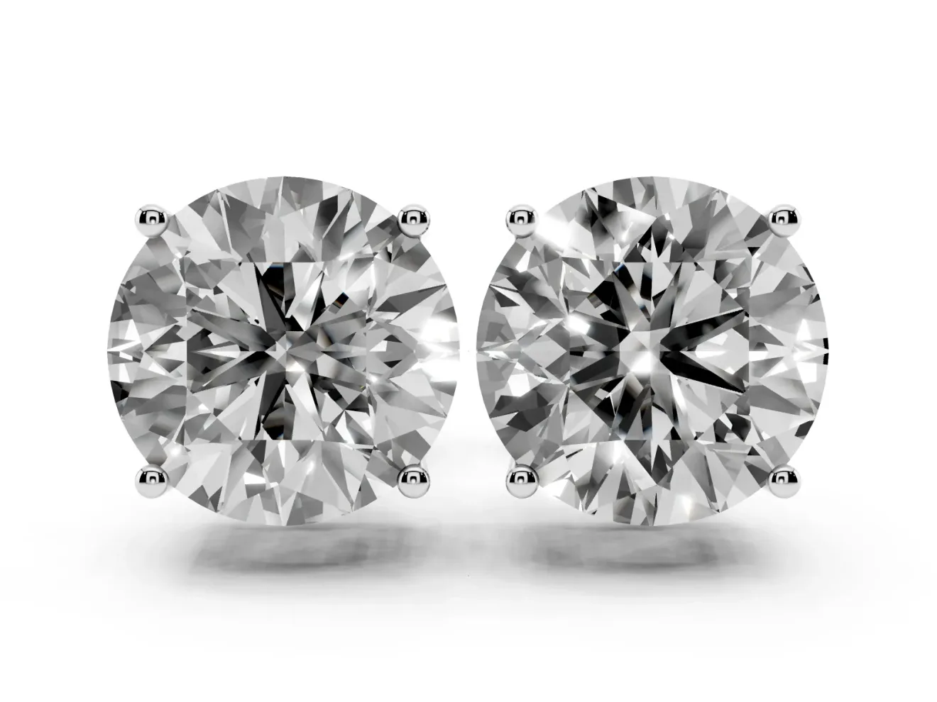 Round Cut Diamond Solitaire Stud Earrings Set in White gold with Basket Setting