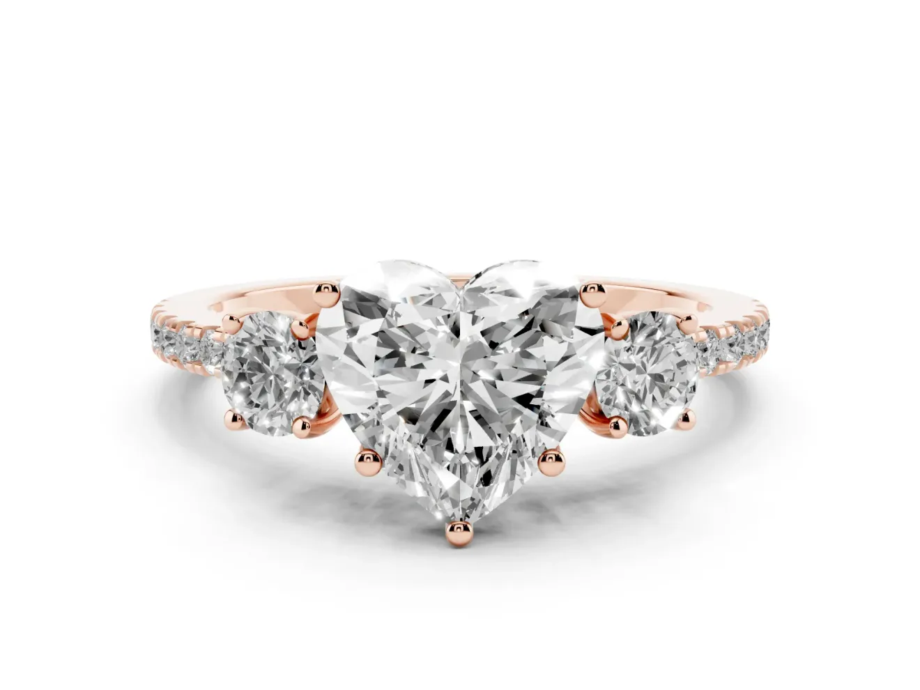 Heart Cut Diamond Three-Stone Ring Set in Rose gold with Pavé Band and Graduated Sides