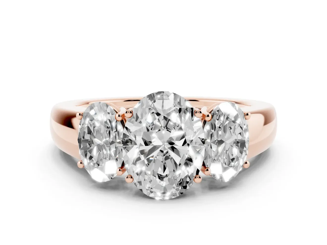 Three-Stone Oval Cut Diamond Ring Set in Rose gold with Matching Prong Settings and Plain Band