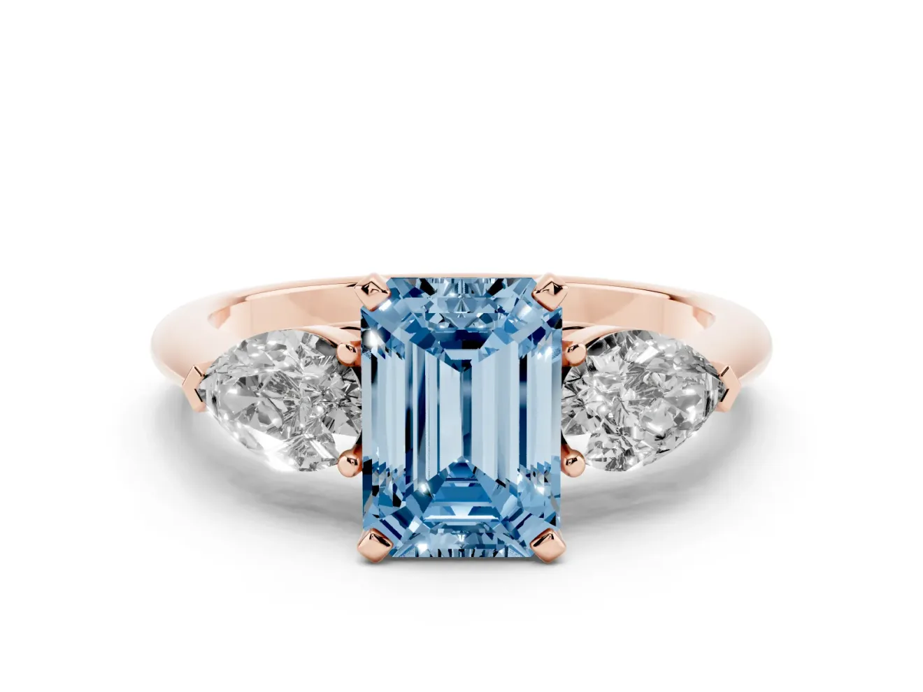 Fancy Blue Three-Stone Emerald Cut Diamond Ring Set in Rose gold with Pear Side Stones and Prong Setting