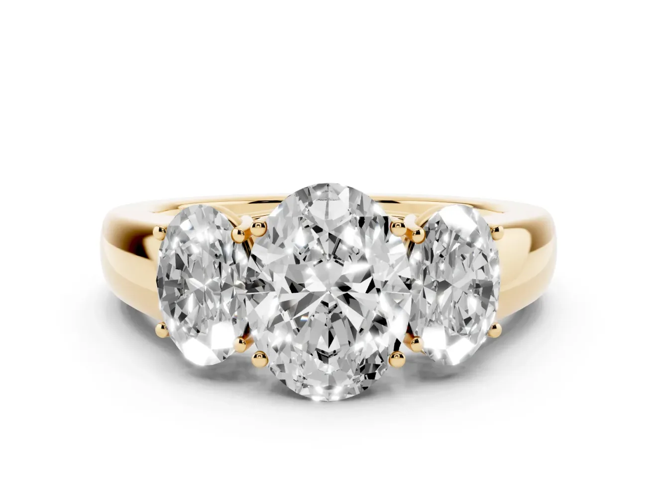 Three-Stone Oval Cut Diamond Ring Set in Yellow gold with Matching Prong Settings and Plain Band