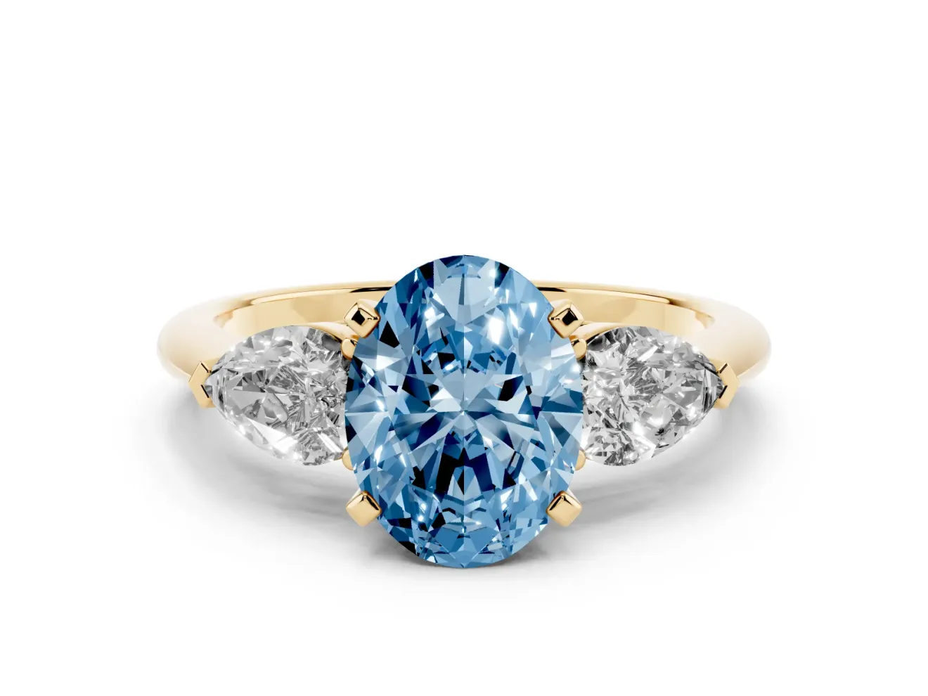Fancy Blue Three-Stone Oval Cut Diamond Ring Set in Yellow gold with Pear Side Stones and Prong Setting