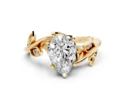Pear Cut Diamond Solitaire Twist Engagement Ring Set in Yellow gold with Pavé Leaf Accents
