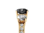 Fancy Black Cushion Cut Diamond Three-Stone Ring Set in Yellow gold with Round Side Stones and Pavé Band