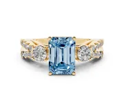Fancy Blue Emerald Cut Diamond Three-Stone Ring Set in Yellow gold with Pavé Split Shank and Prong Setting