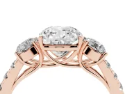 Cushion Cut Diamond Three-Stone Ring Set in Rose gold with Round Side Stones and Delicate Pavé Band