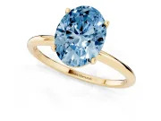 Fancy Blue Oval Cut Diamond Solitaire Engagement Ring Set in Yellow gold with Thin Band and Prong Setting