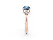 Fancy Blue Princess Cut Diamond Cluster Ring Set in Rose gold with Round Accent Stones and Prong Setting on a Plain Band