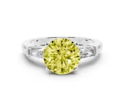 Fancy Yellow Round Cut Diamond Solitaire Ring Set in White gold with Tapered Baguette Side Stones and Prong Setting