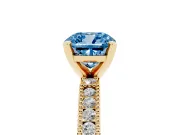 Fancy Blue Cushion Cut Diamond Solitaire Ring Set in Yellow gold with Slim Pavé Band and Prong Setting