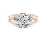Three-Stone Oval Cut Diamond Ring Set in Rose gold with Prong Setting and Plain Band