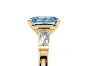 Fancy Blue Emerald Cut Diamond Solitaire Ring Set in Yellow gold with Tapered Baguette Accents and Prong Setting