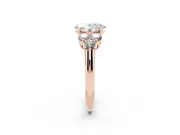 Oval Cut Diamond Cluster Ring Set in Rose gold with Round Accent Stones and Prong Setting on a Plain Band