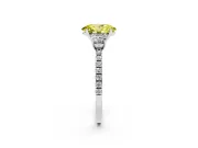 Fancy Yellow Oval Cut Diamond Three-Stone Ring Set in Platinum with Pavé Band and Graduated Sides