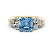 Fancy Blue Asscher Cut Diamond Cluster Ring Set in Yellow gold with Round Accent Stones and Prong Setting on a Plain Band