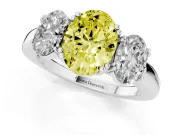 Fancy Yellow Oval Cut Diamond Three-Stone Ring Set in White gold with Polished Band and Prong Setting