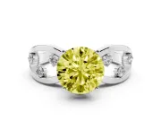 Fancy Yellow Round Cut Diamond Solitaire Ring Set in White gold with Side Stones on Criss-Cross Band and Prong Setting