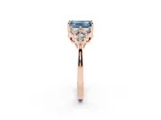 Fancy Blue Emerald Cut Diamond Solitaire Ring Set in Rose gold with Cluster Accents on Each Side