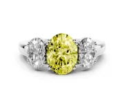 Fancy Yellow Oval Cut Diamond Three-Stone Ring Set in White gold with Polished Band and Prong Setting