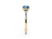 Fancy Blue Princess Cut Diamond Solitaire Set in Yellow gold with Side Baguettes and Channel Set Band