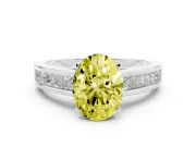 Fancy Yellow Oval Cut Diamond Solitaire Ring Set in White gold with Channel-Set Band and Prong Setting