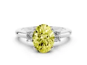 Fancy Yellow Three-Stone Oval Cut Diamond Ring Set in Platinum with Prong Setting and Plain Band